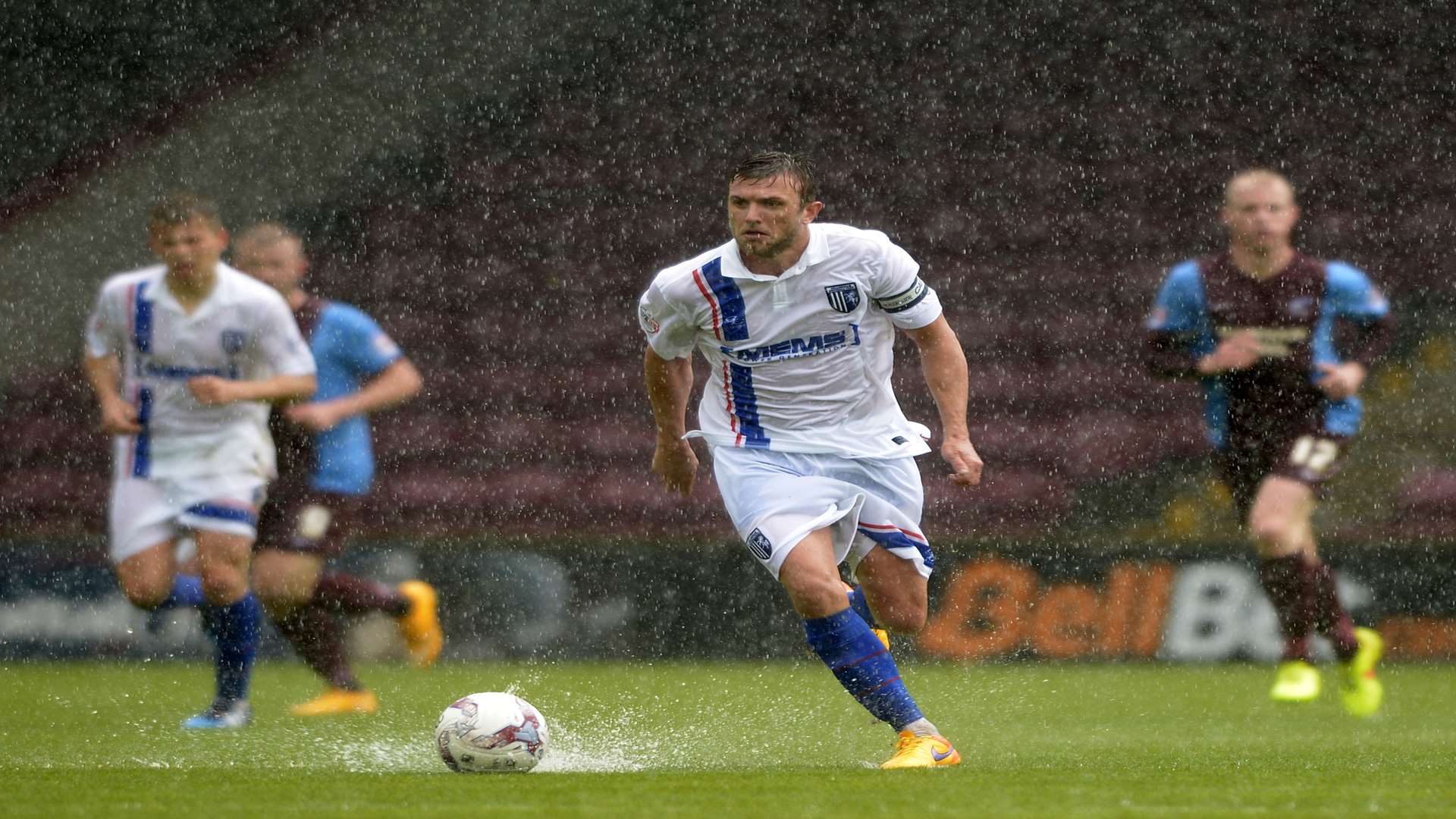 Doug Loft dribbles the ball through a puddle Picture: Barry Goodwin