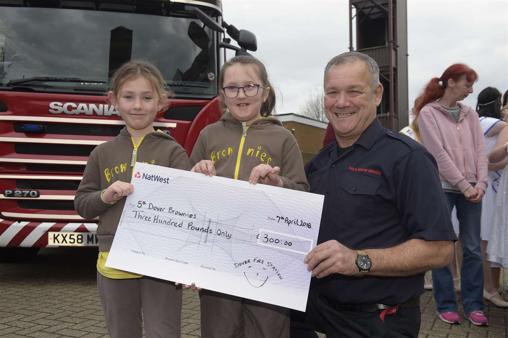 Dover Fire Station, Dover. Cheque presentations. Bobby-Jo Biggs aged eight and Caitlyn Foster aged ten receive a cheque from Roger Hadfield.Picture: Tony Flashman (1413934)