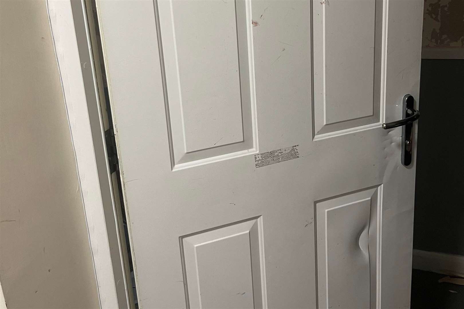 A damaged and blood-stained door at the flat