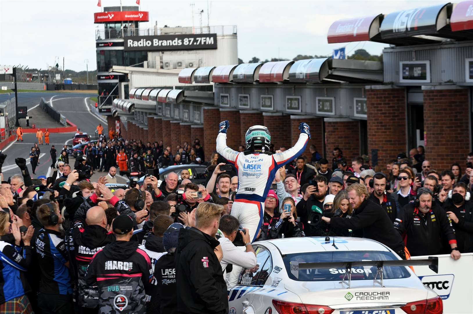Ash Sutton celebrates winning the British Touring Car Championship title for the third time after finishing sixth in race two