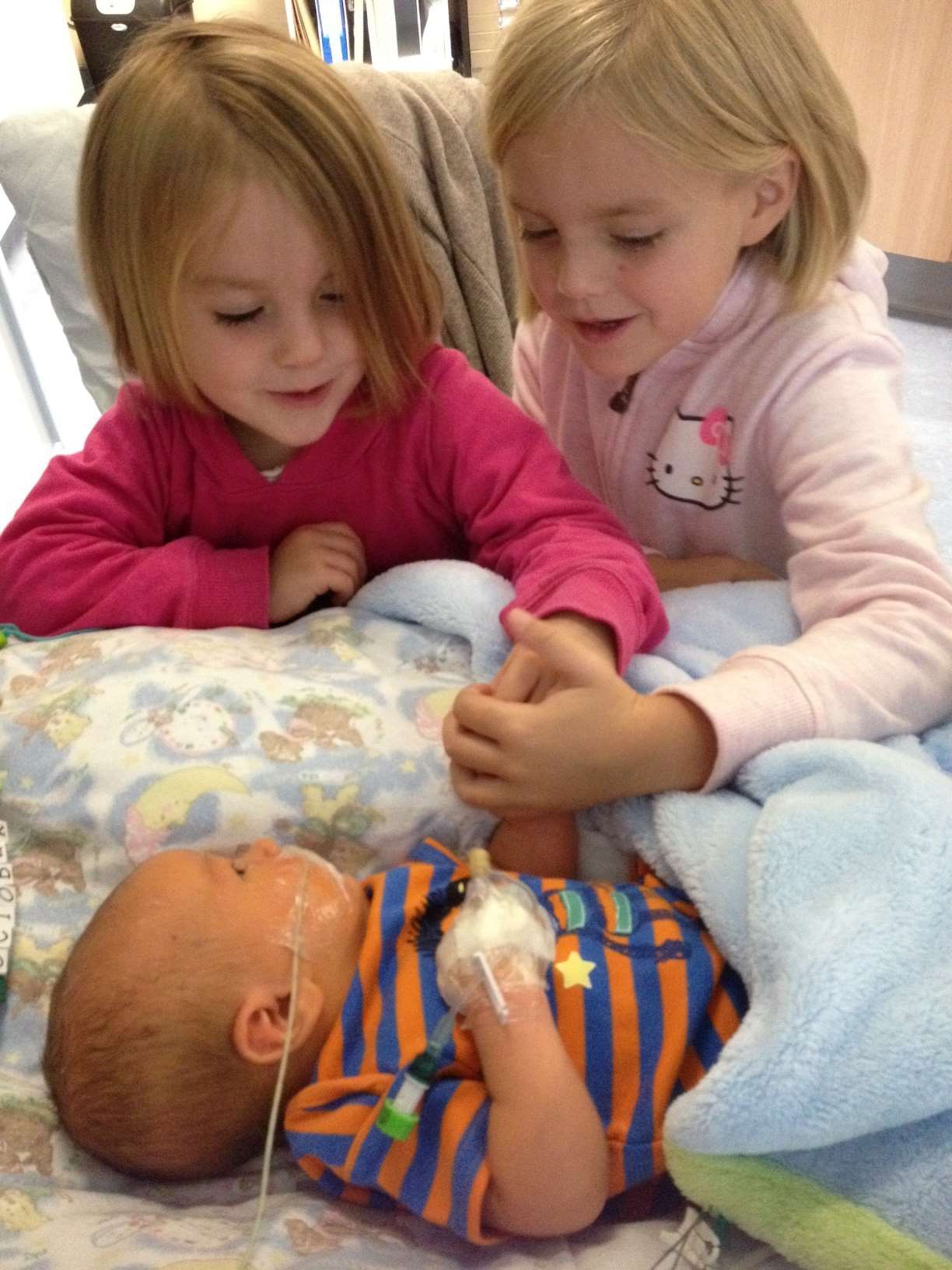 Theo with big sisters Mia and Jessica
