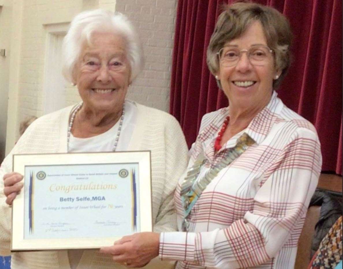 Betty presented with her certificate by the District 12 chairman Christine Head-Rapson