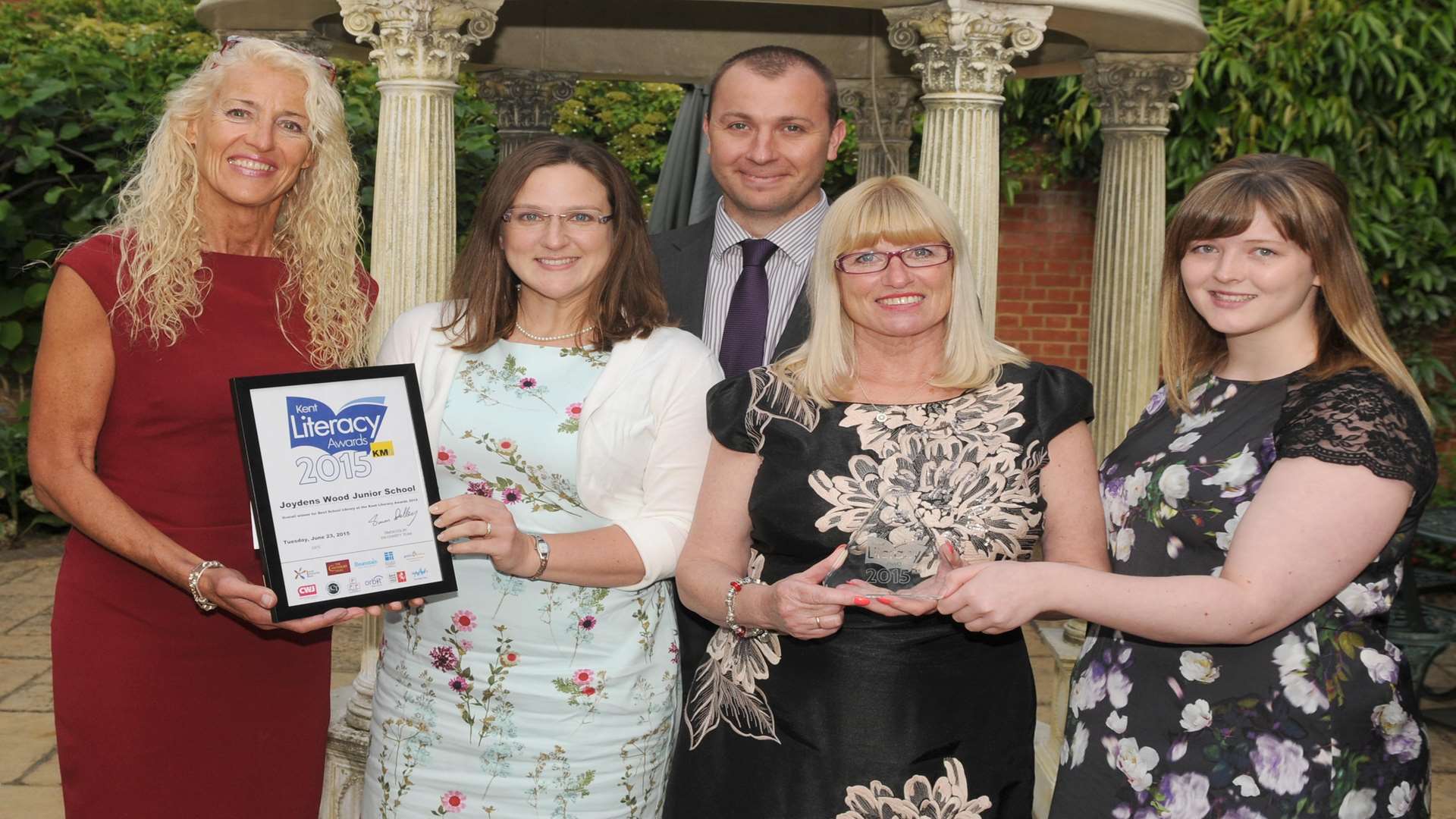 Mandy Holdstock of Hempstead House (left) and Bethany Taylor (right) of Canterbury Tales present the team from Joydens Wood Junior School with the Best School Library Award at the Kent Literacy Awards 2015.