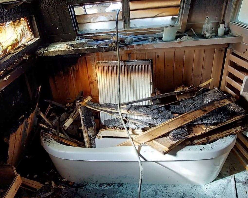 The fire brigade had to rip the wood panelling off of John's bathroom to make sure the flames were out