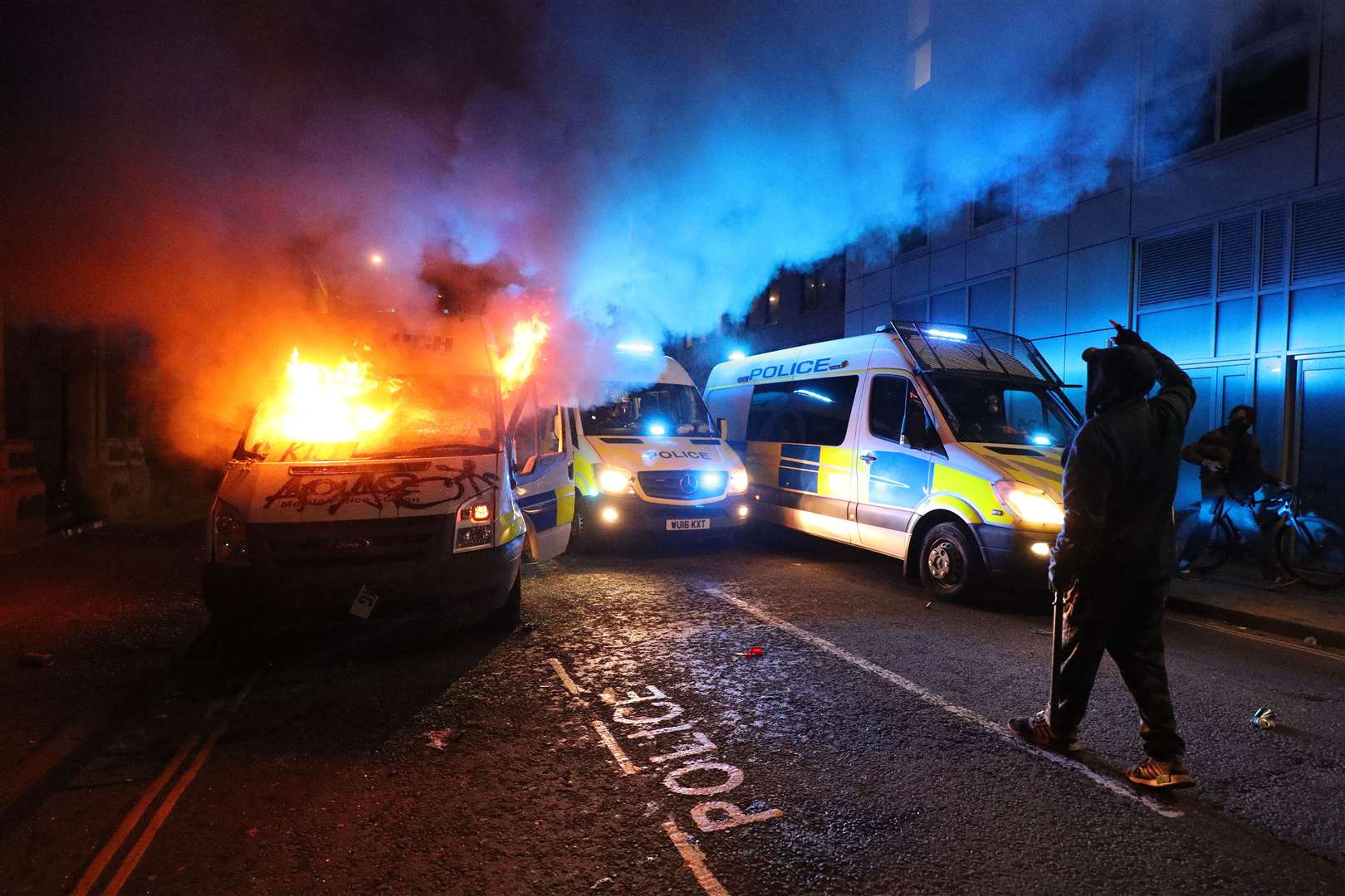 A vandalised police van on fire outside Bridewell police station on March 21 (Andrew Matthews/PA)
