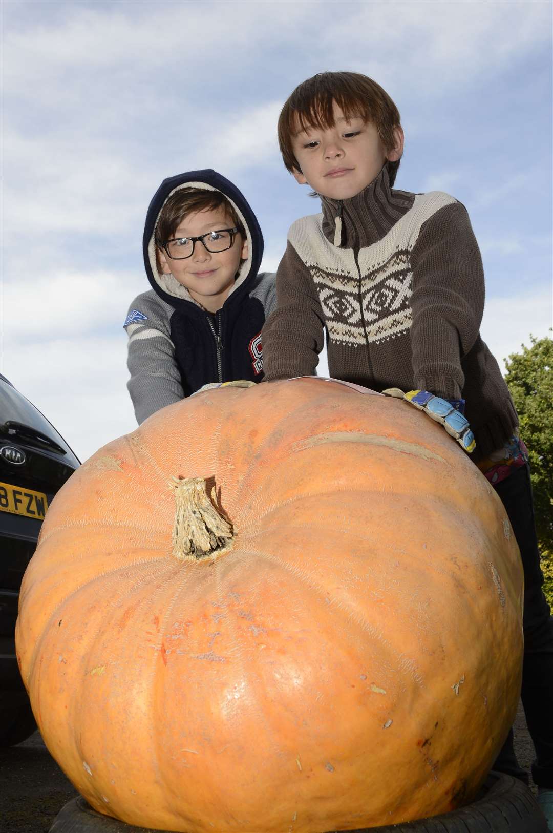 Charlie Oates-Wong, 7, and Archie Oates-Wong, 9, with the 57.4 kilo monster they grew for the Ashford Westrees Allotments Pumpkin competition