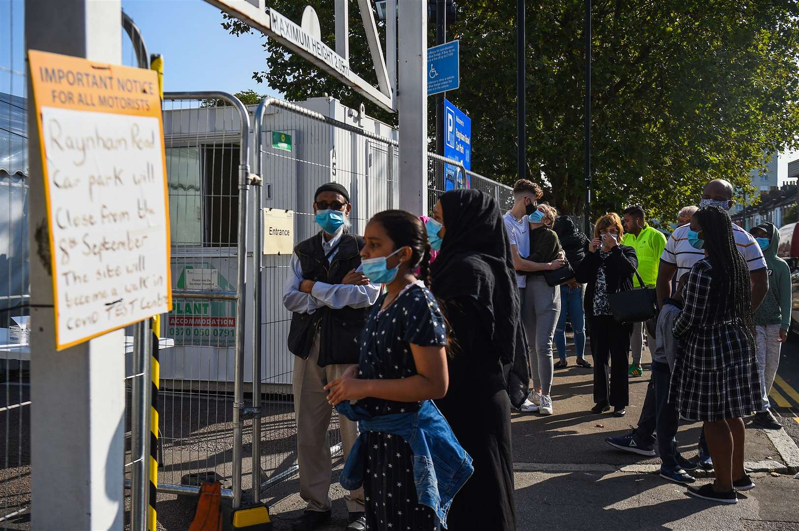 People queue outside a coronavirus testing centre offering walk-in appointments in north London (Kirsty O’Connor/PA)