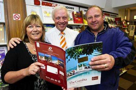 Sharon and Sean D'Alton, with David Lynch, manager of Sheerness Travel, centre, look over a brochure for Gambia