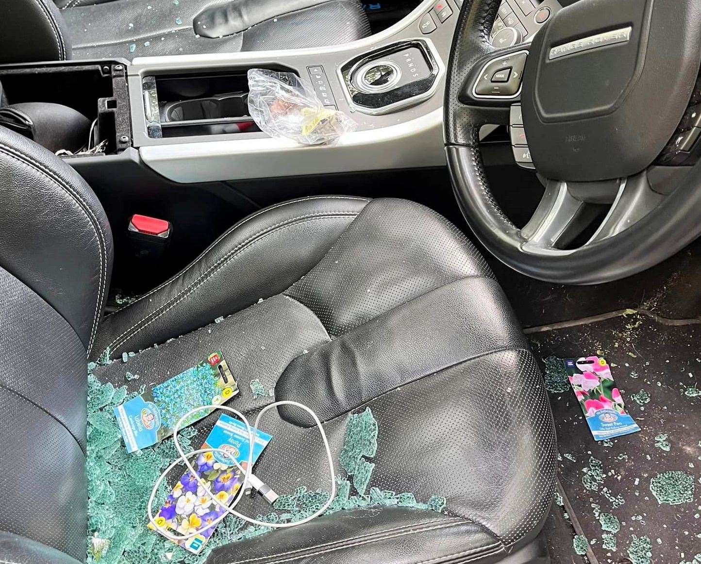 The car window was smashed, leaving glass covering the seats