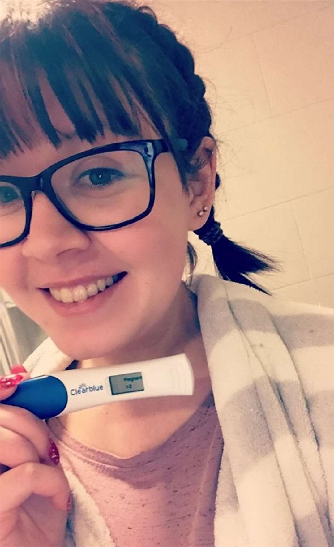Maxine Campbell with pregnancy test result. Picture: SWNS