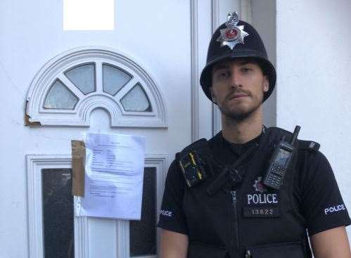 A police officer outside the anti-social flat in The Grove, Gravesend. Picture: Kent Police