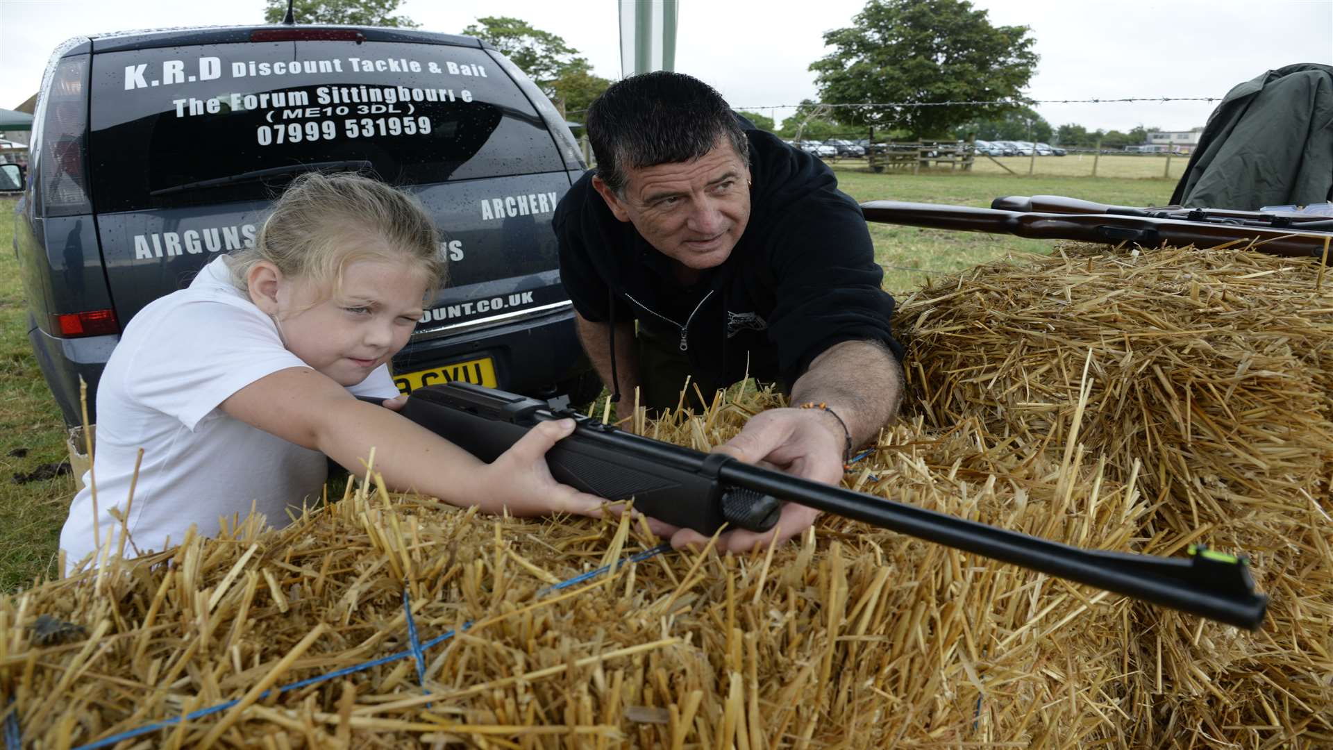 Holly Russell takes aim with instructor Bernie George at the Holm Place Farm fun day