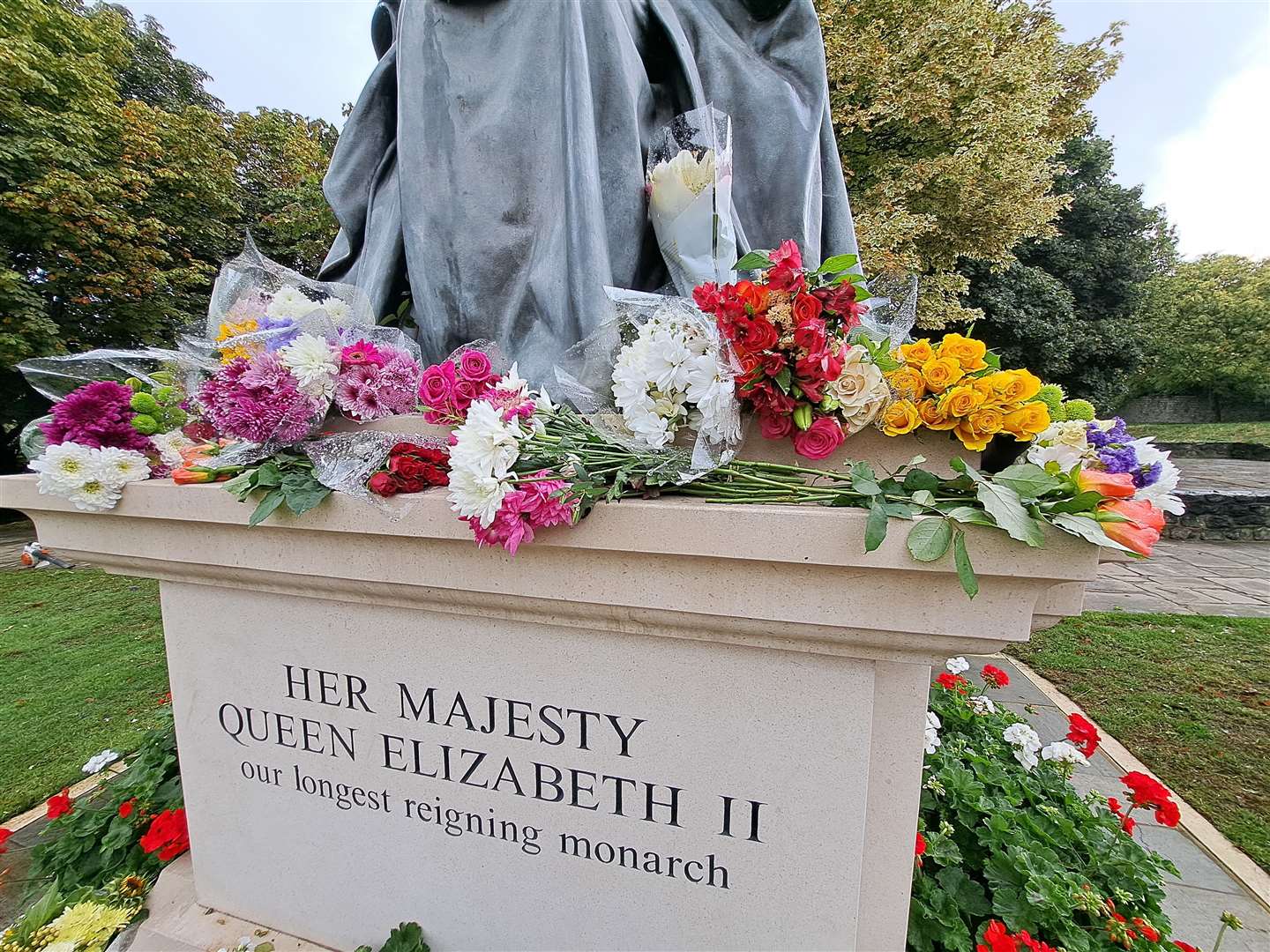 Residents have placed flowers on the Queen Elizabeth II statue in St Andrew's Gardens, Gravesend