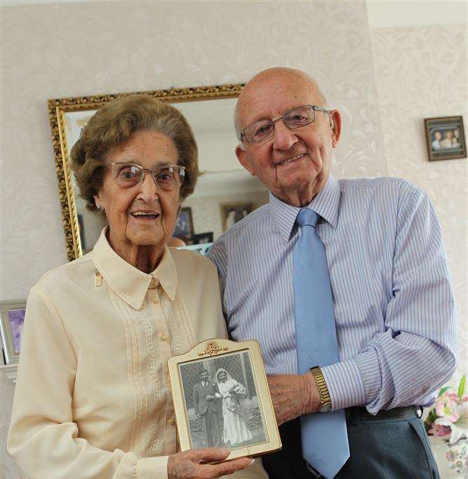 Bob Bridge with his wife Lily celebrating their 70th wedding anniversary. They are pictured holding up their wedding picture at their Sittingbourne home.