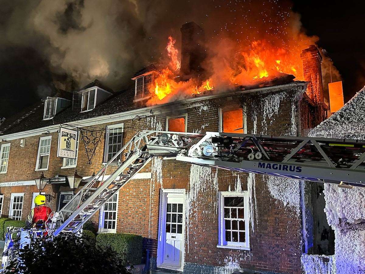 Firefighters battling the blaze at the historic pub. Image: UKNIP