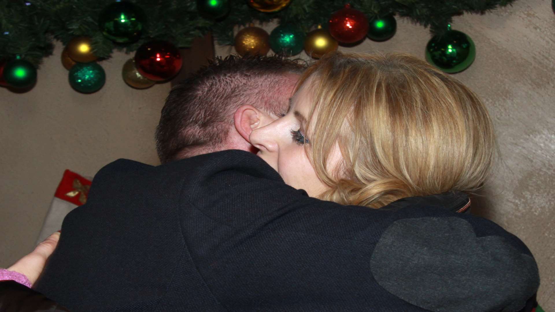 Graham Jones and Fiona Robertson hug after his marriage proposal in Santa’s Grotto.Photograph courtesy of www.Photo-Team.co.uk