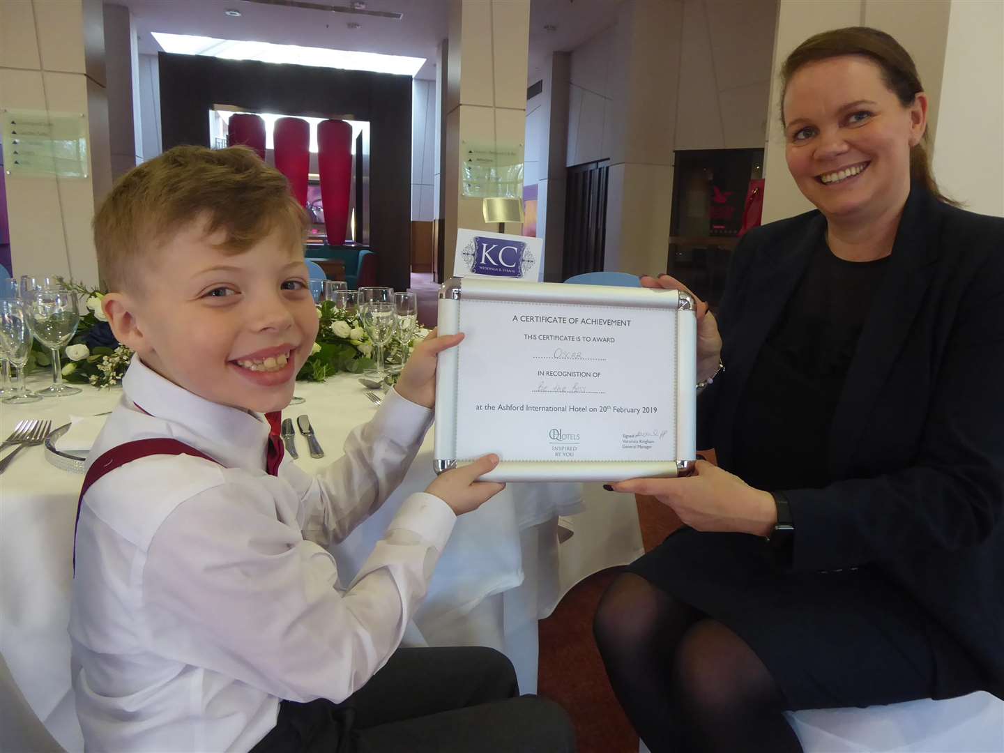 Oscar Hollis, eight, of Tiger Primary School in Maidstone, receives a Be the Boss certificate from Lynette Wood of Ashford International Hotel.