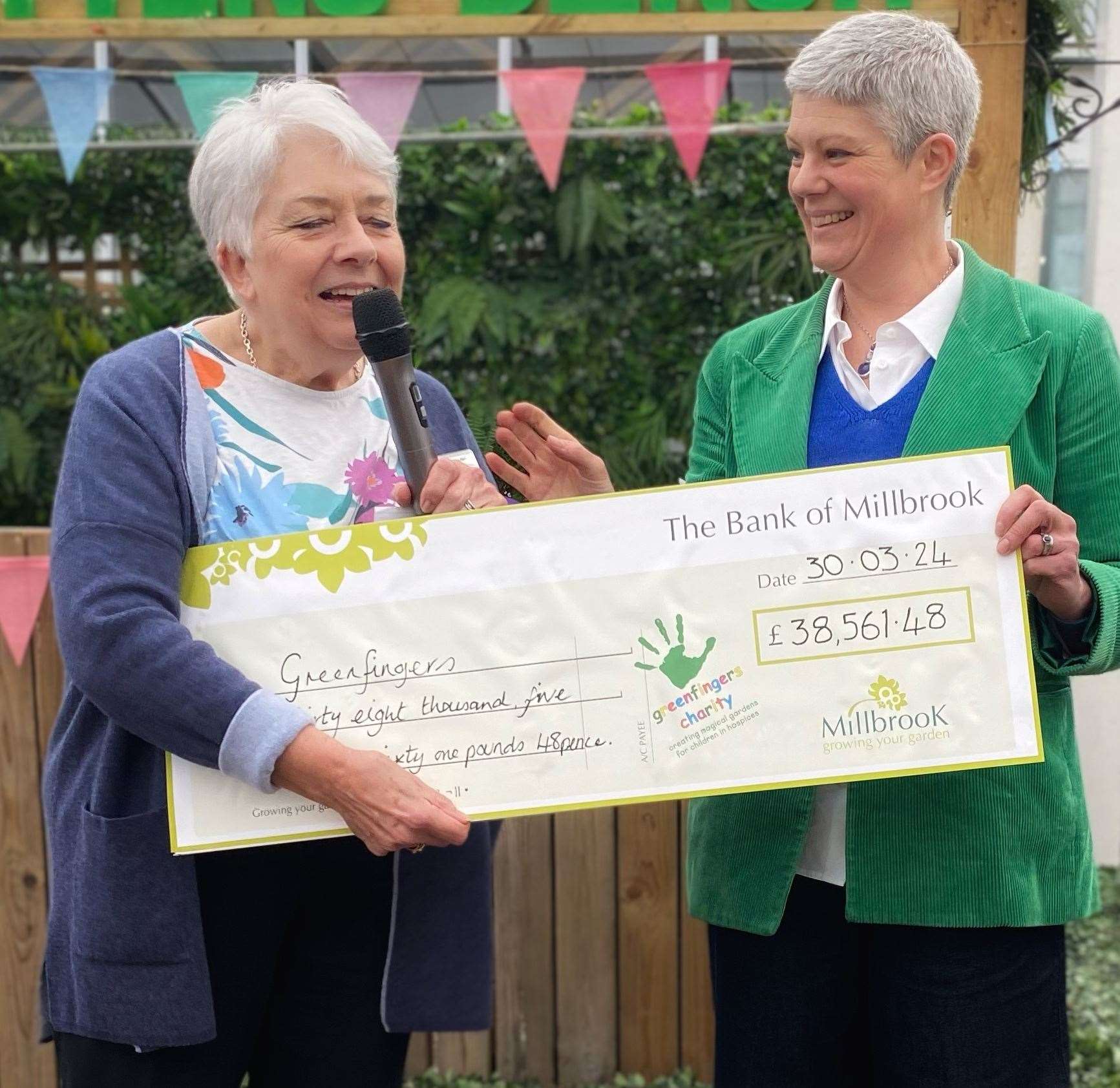 Greenfingers’ Chairman, Sue Allen, receiving the cheque from her daughter, Tammy Woodhouse, Managing Director of Millbrook Garden Company. Photo: Millbrook Garden Company.