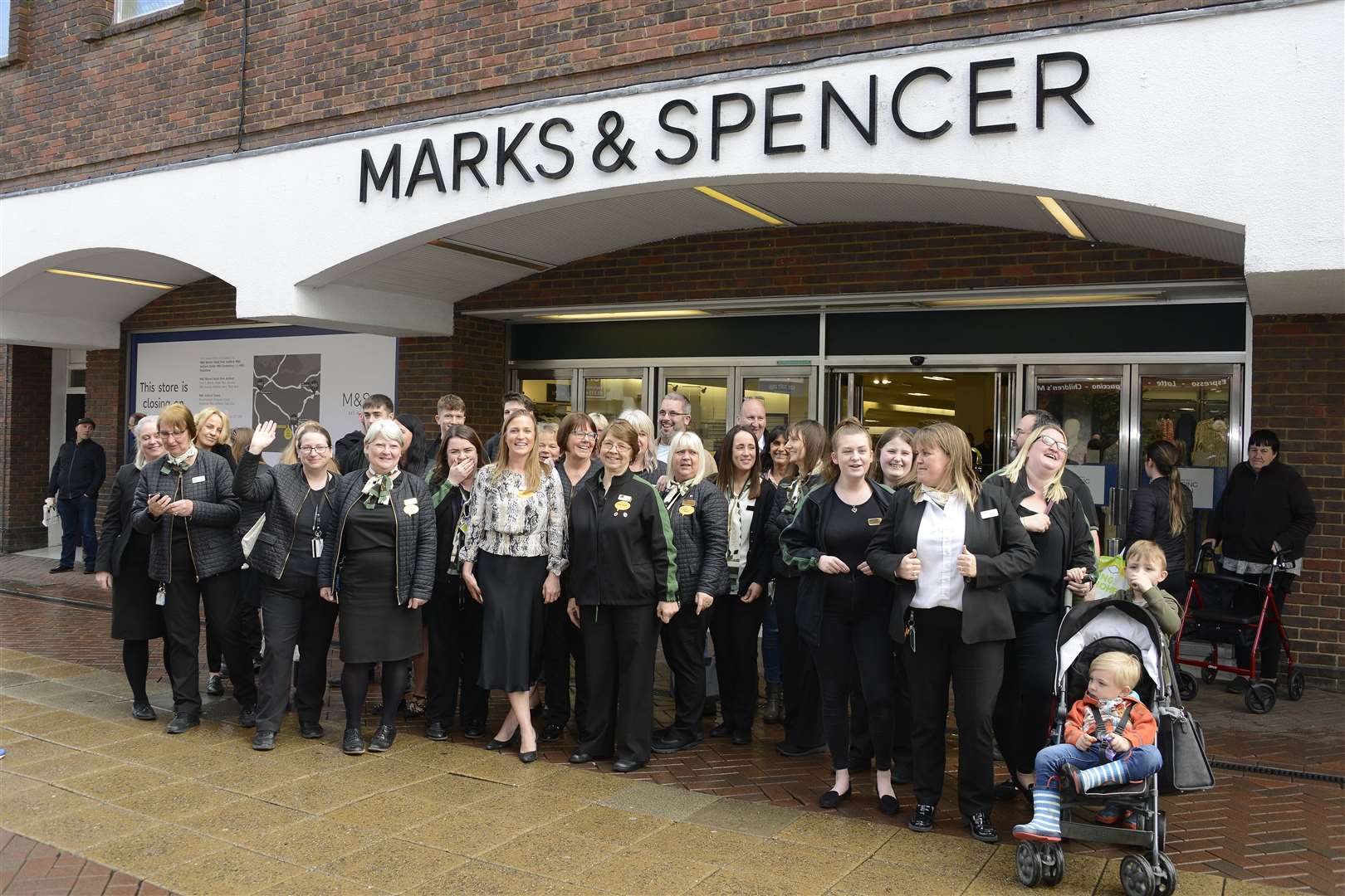 Staff wave to thank customers for their support as the M&S store in Ashford closed