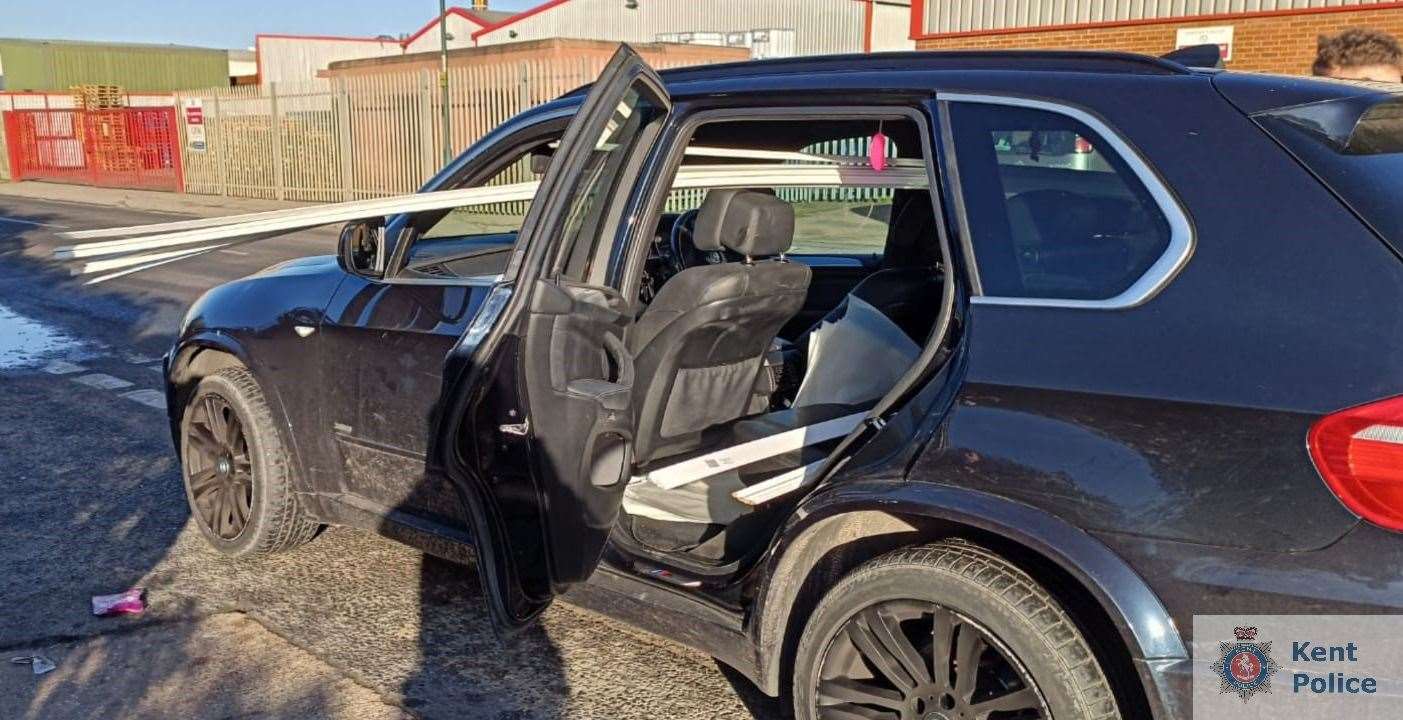 A driver in Rochester caught with skirting boards hanging out of the window of a BMW has been handed a driving conviction for the unsafe load. Picture: Kent Police