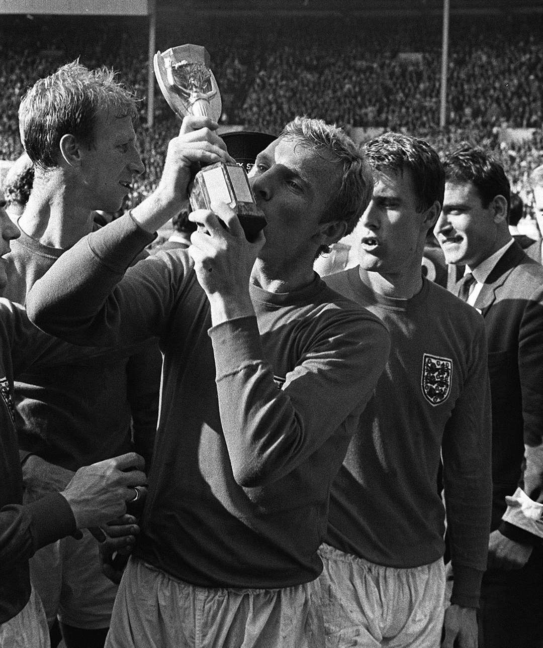 1966: Bobby Moore kisses the World Cup trophy he had just received from The Queen