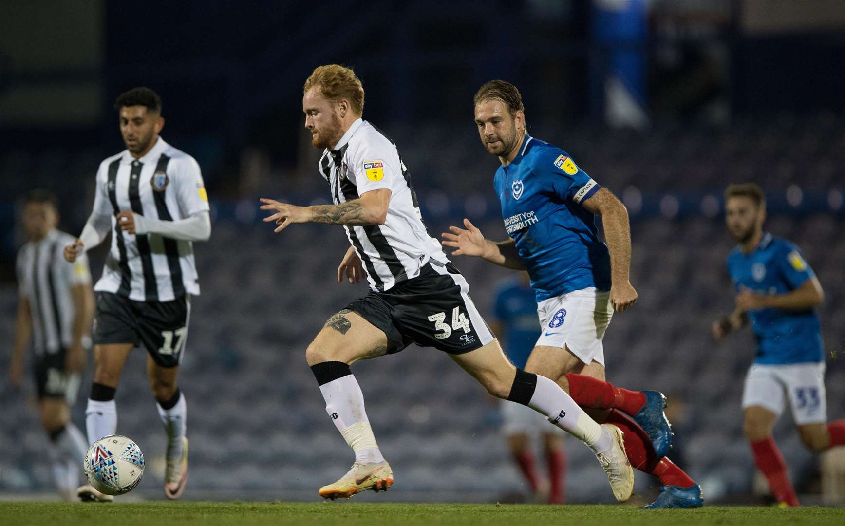 Gillingham’s Connor Ogilvie gets away from Brett Pitman during the Checkatrade Trophy match at Portsmouth Picture: Ady Kerry