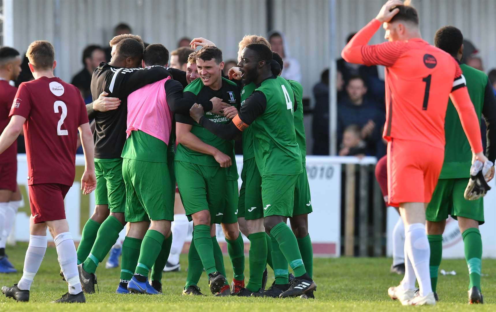 Jack Delo, right, walks off as Cray's players celebrate at the final whistle at Salters Lane on Saturday Picture: Keith Gillard
