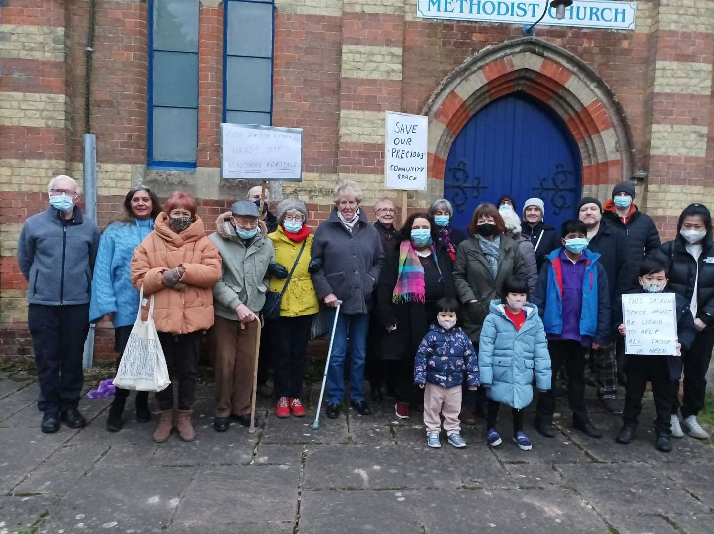 Villagers gather in dismay outside the church after hearing abut the renewed auction bid