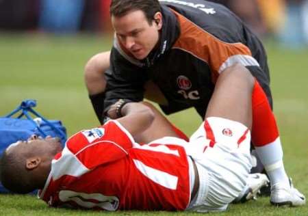 Darren Bent receives treatment on the pitch after hurting his knee against Aston Villa. Picture: MATT WALKER