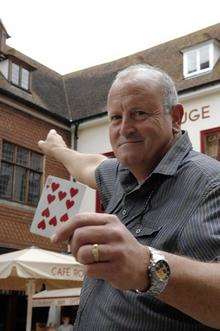 Brian Thompson points out where a card landed on the roof of the Cafe Rouge from a magician operating in Canterbury's Longmarket area.