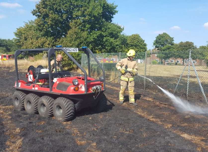 Crews tackle the fire in a field off Querns Road in Canterbury
