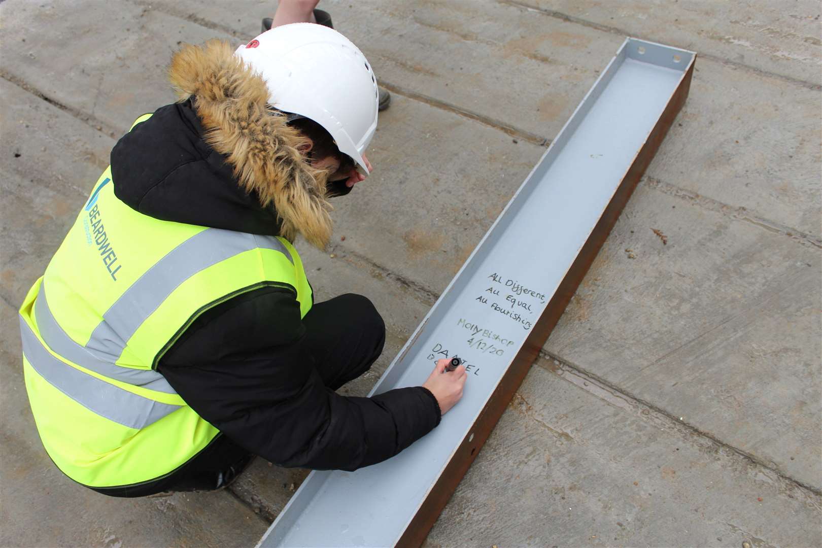 Pupil Daniel Bowie inscribes his name onto the final steel frame for the new teaching block. Picture: Maisie Walker, Aletheia Anglican Academies Trust