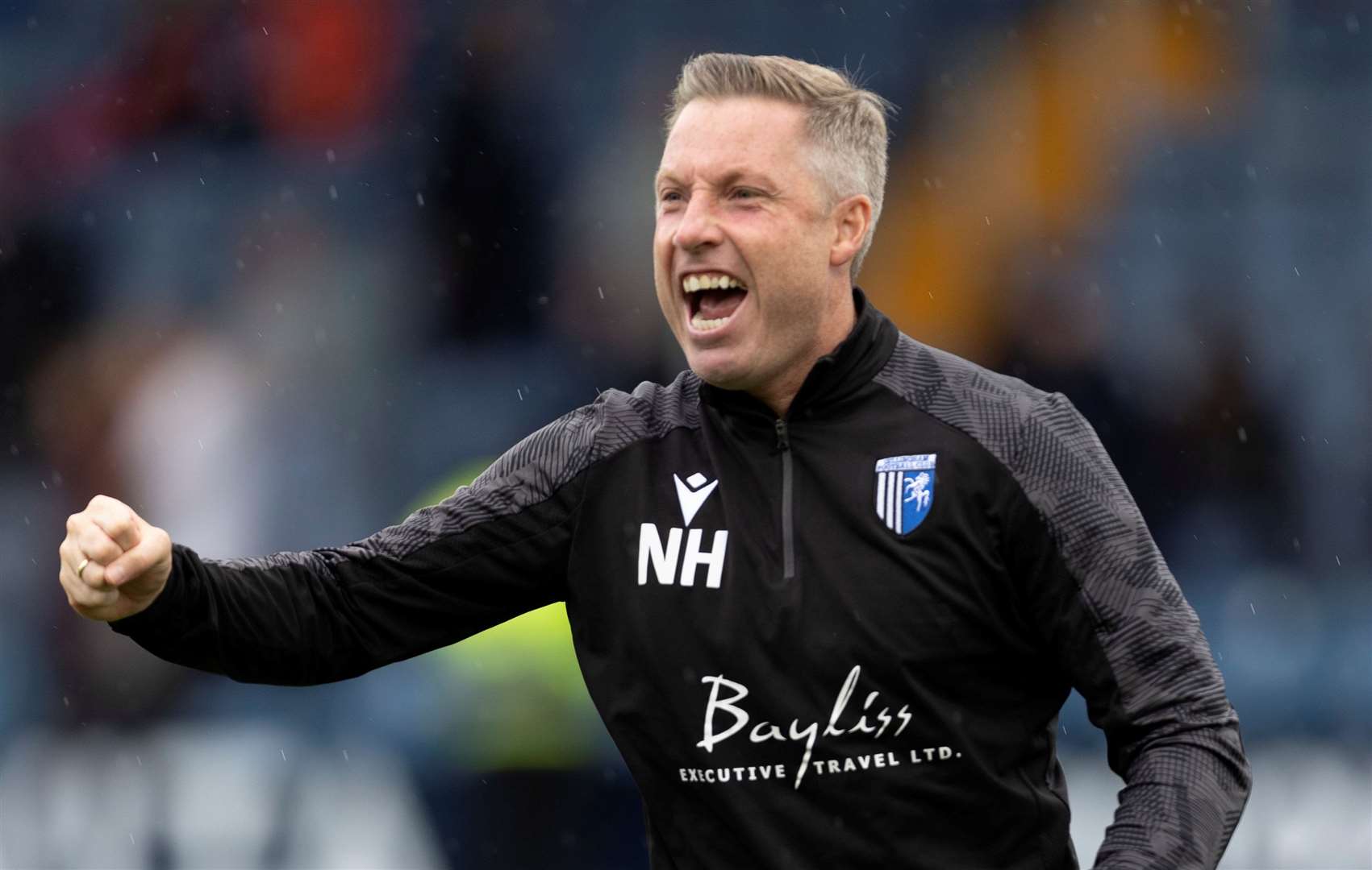 Gillingham manager Neil Harris celebrates their win at Stockport on Saturday. Picture: @Julian_KPI