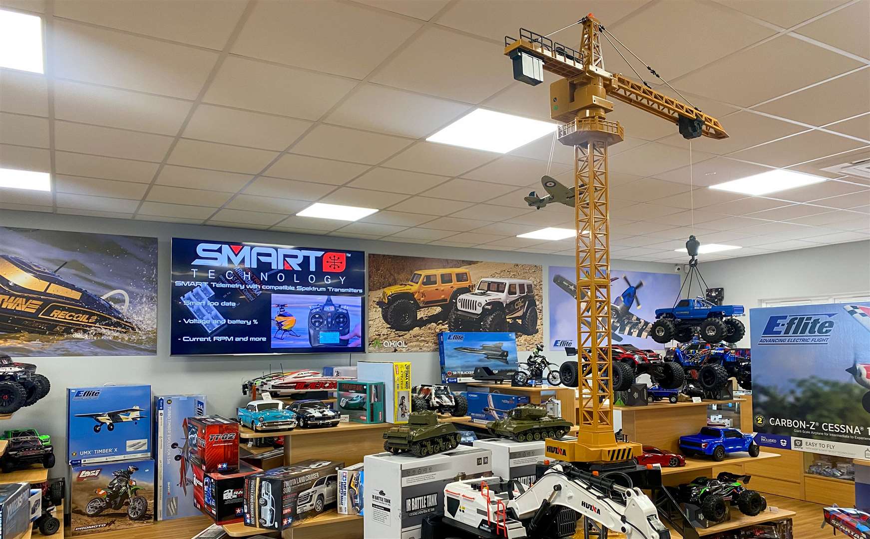 The shop is filled with models, remote control cars, posters and even a TV screen showing instructional videos
