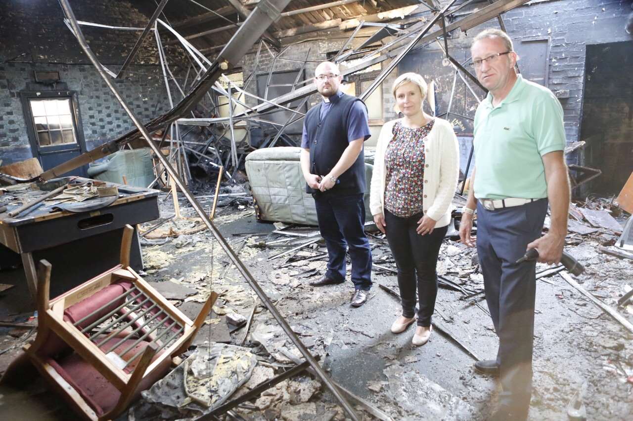 Members of St Francis Church assess the aftermath