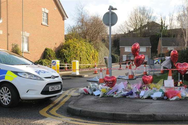 A police car close to the spot where Kevin McKinley was shot in Dartford - where floral tributes were laid