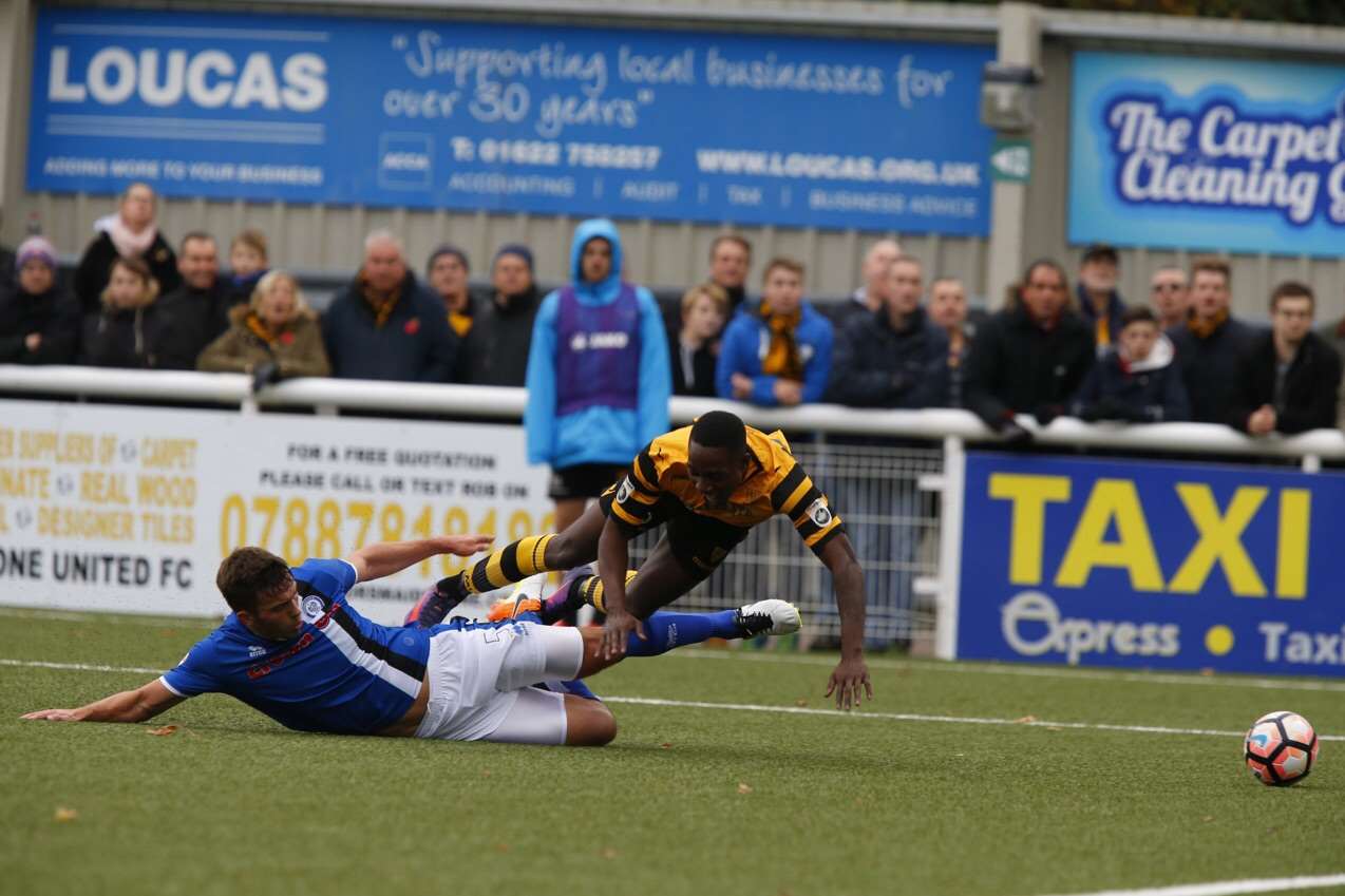 Jamar Loza is taken out by Niall Canavan for Maidstone's penalty Picture: Andy Jones