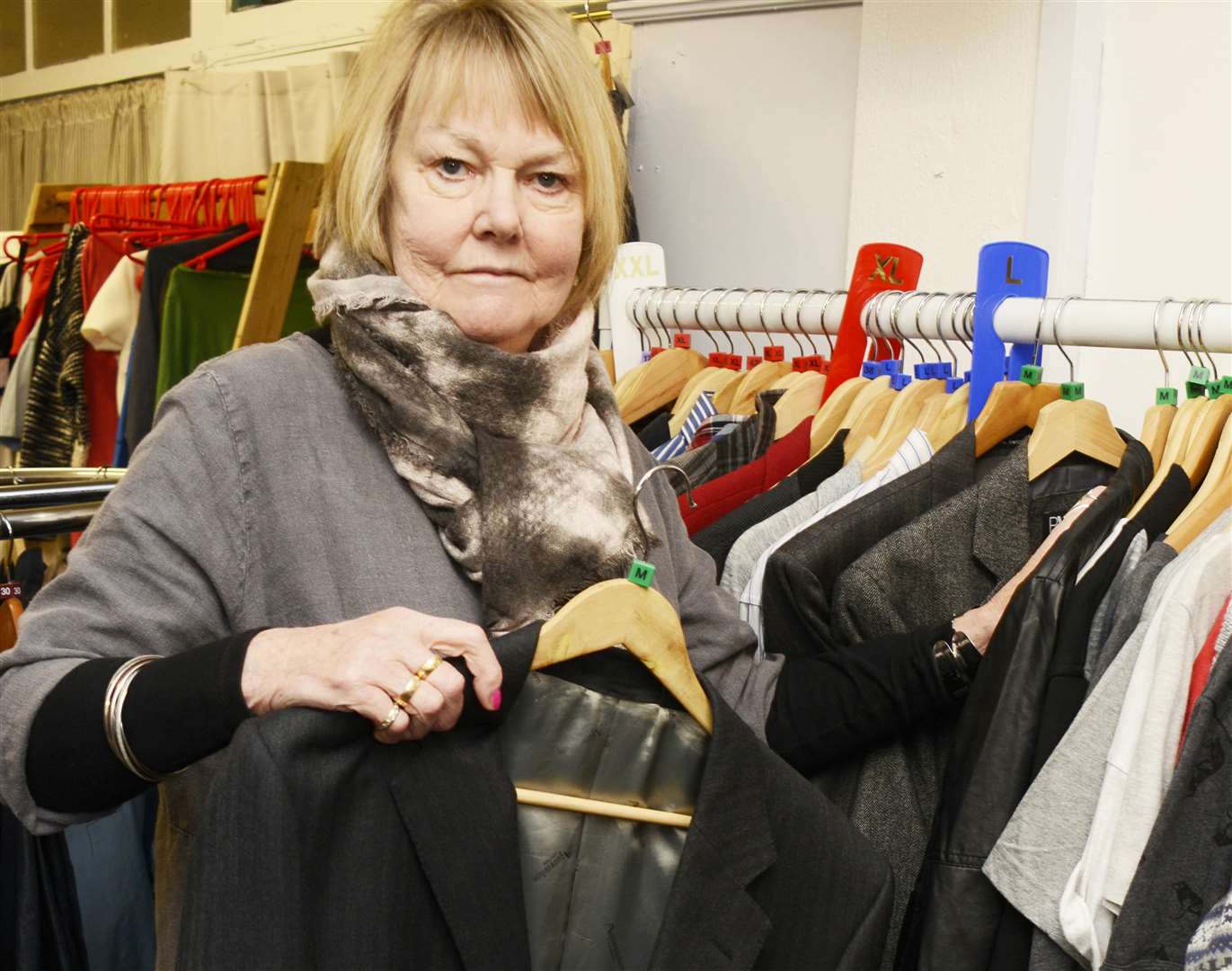 Brenda, a volunteer at Relate Charity shop, replacing a coat that was taken. Picture: Paul Amos