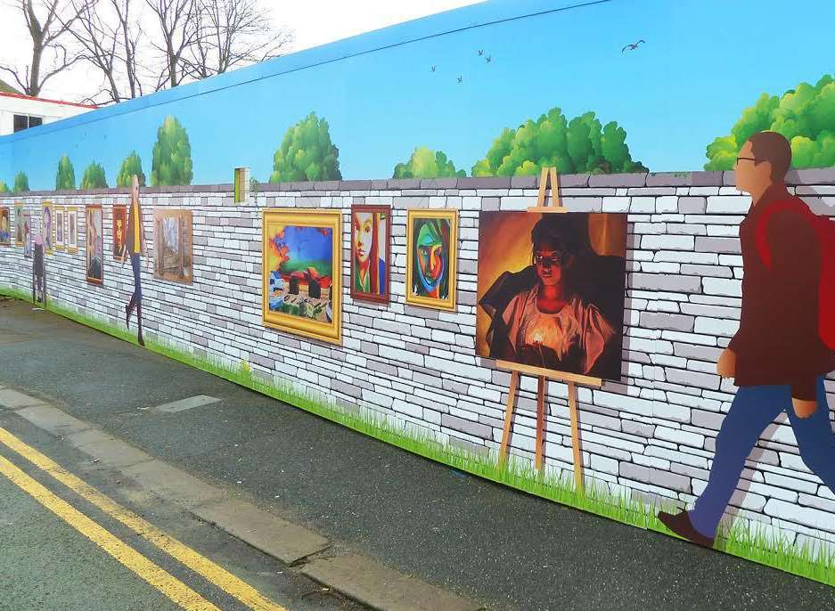 The artistic hoardings have been erected around the site where eight new council flats are being constructed