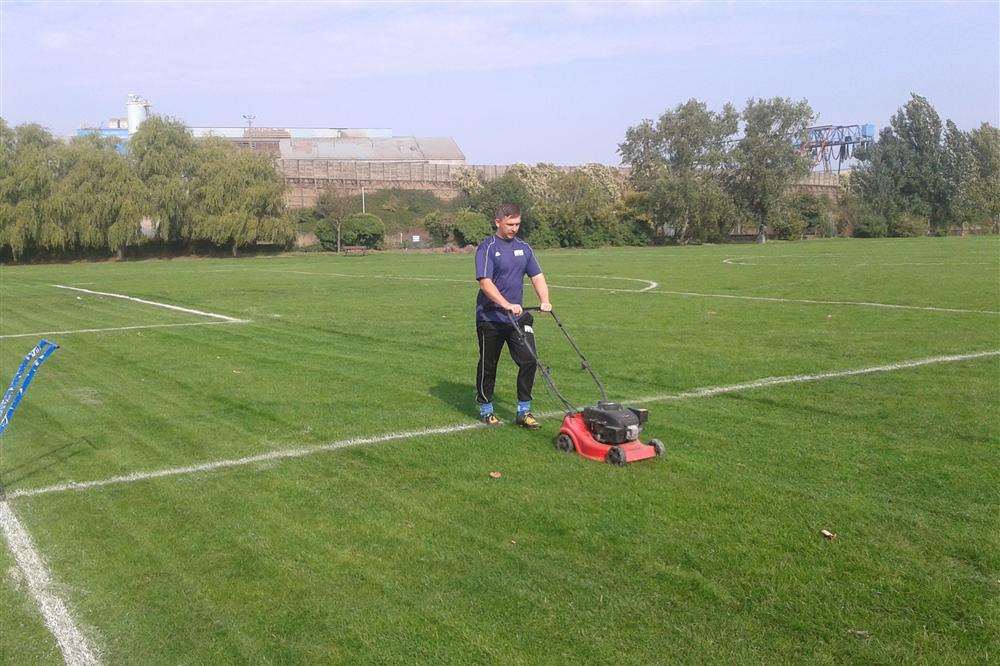 Wayne Want, manager of New Road under-14s, cutting the long grass