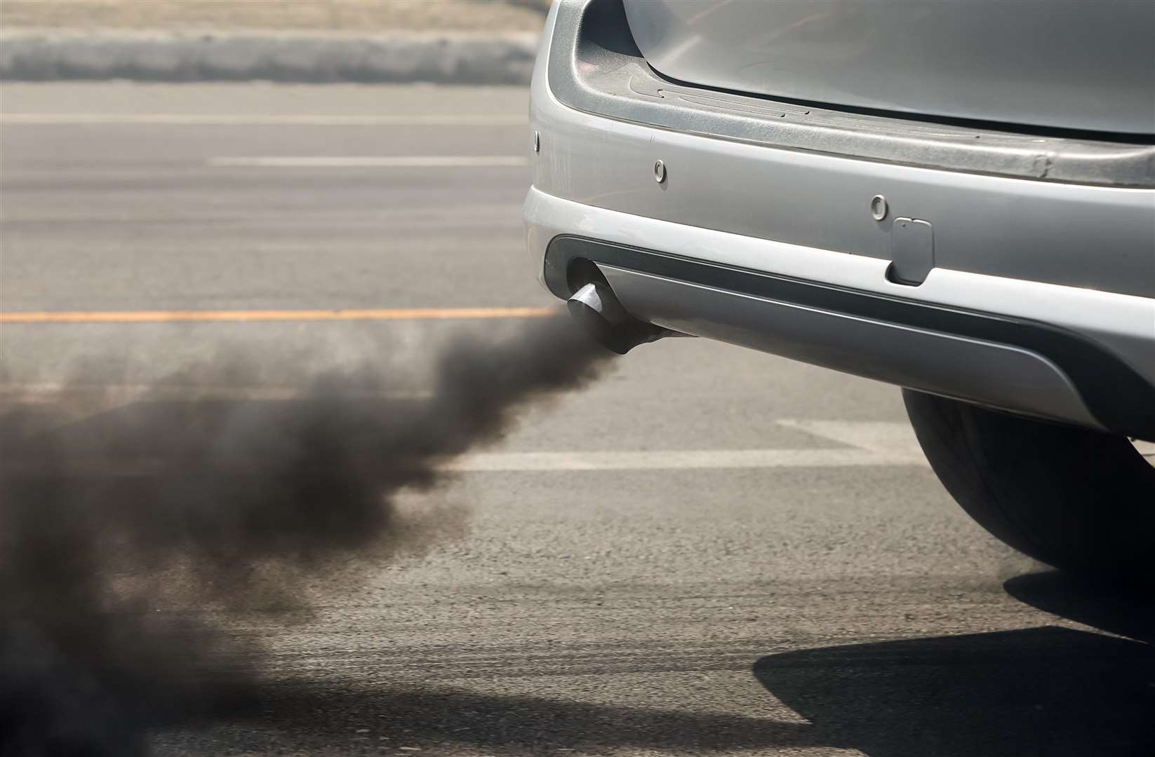 Air pollution from vehicle exhaust pipe on road. (6623325)