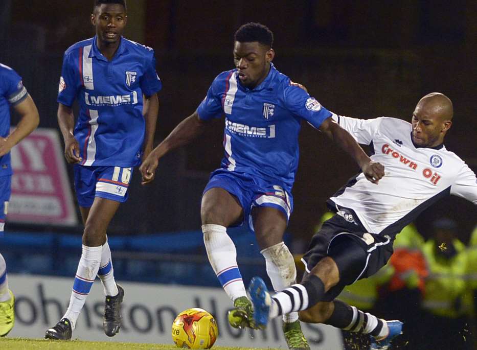 Deji Oshilaja is tackled by Rochdale's Calvin Andrew