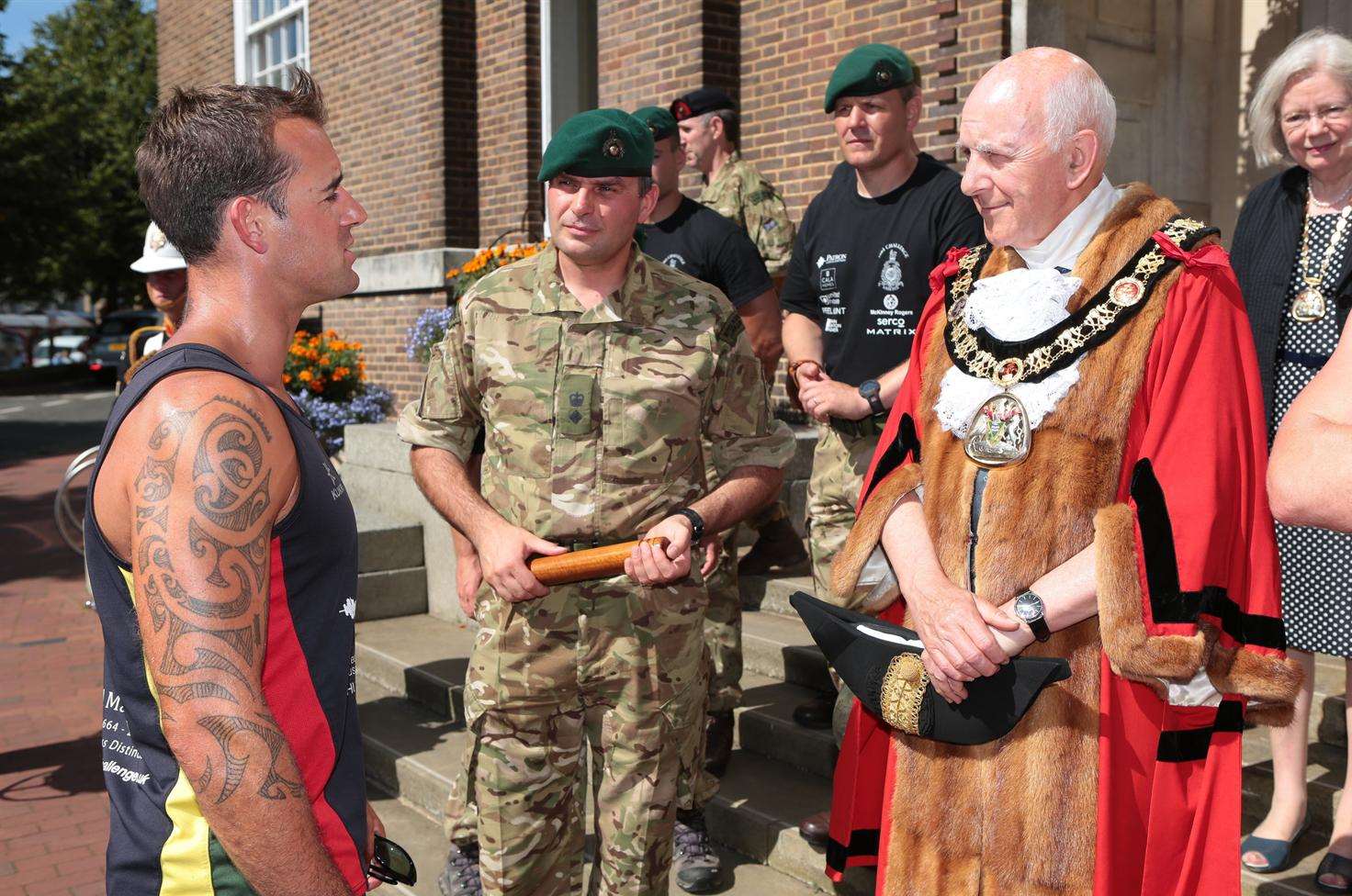 CSgt Richard Hayden, of 40 Commando, Col Neil Watkinson, Mayor Cllr Julian Stanyer on the steps of the town hall during the baton handover as part of the 1664 Challenge