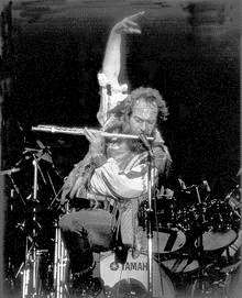 Ian Anderson performing on his trademark one leg in his earlier Jethro Tull days