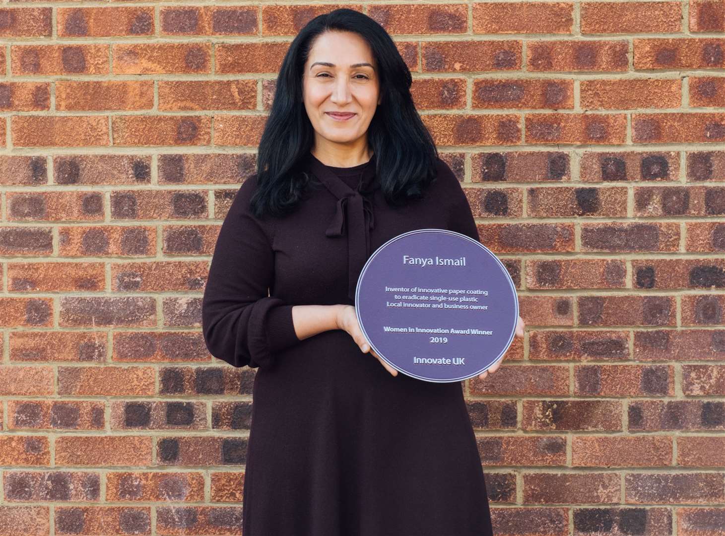Fanya Ismail holing a blue plaque from Innovate UK. Picture by Jennifer McCord (7647176)