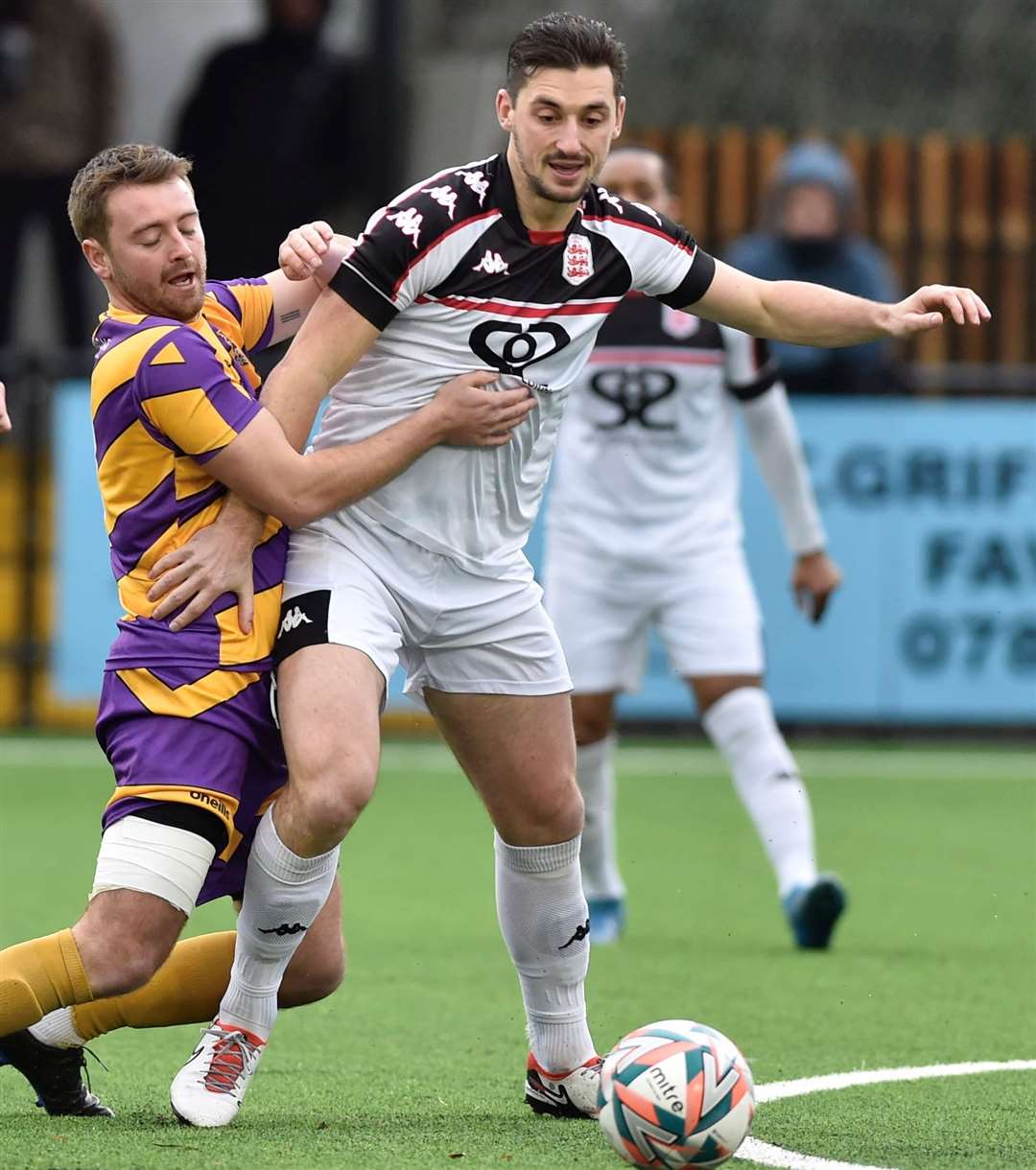 Faversham midfielder Sam Hasler in the thick of the action against Deal's Macauley Murray during the Lilywhites’ 4-2 weekend home defeat. Picture: Ian Scammell