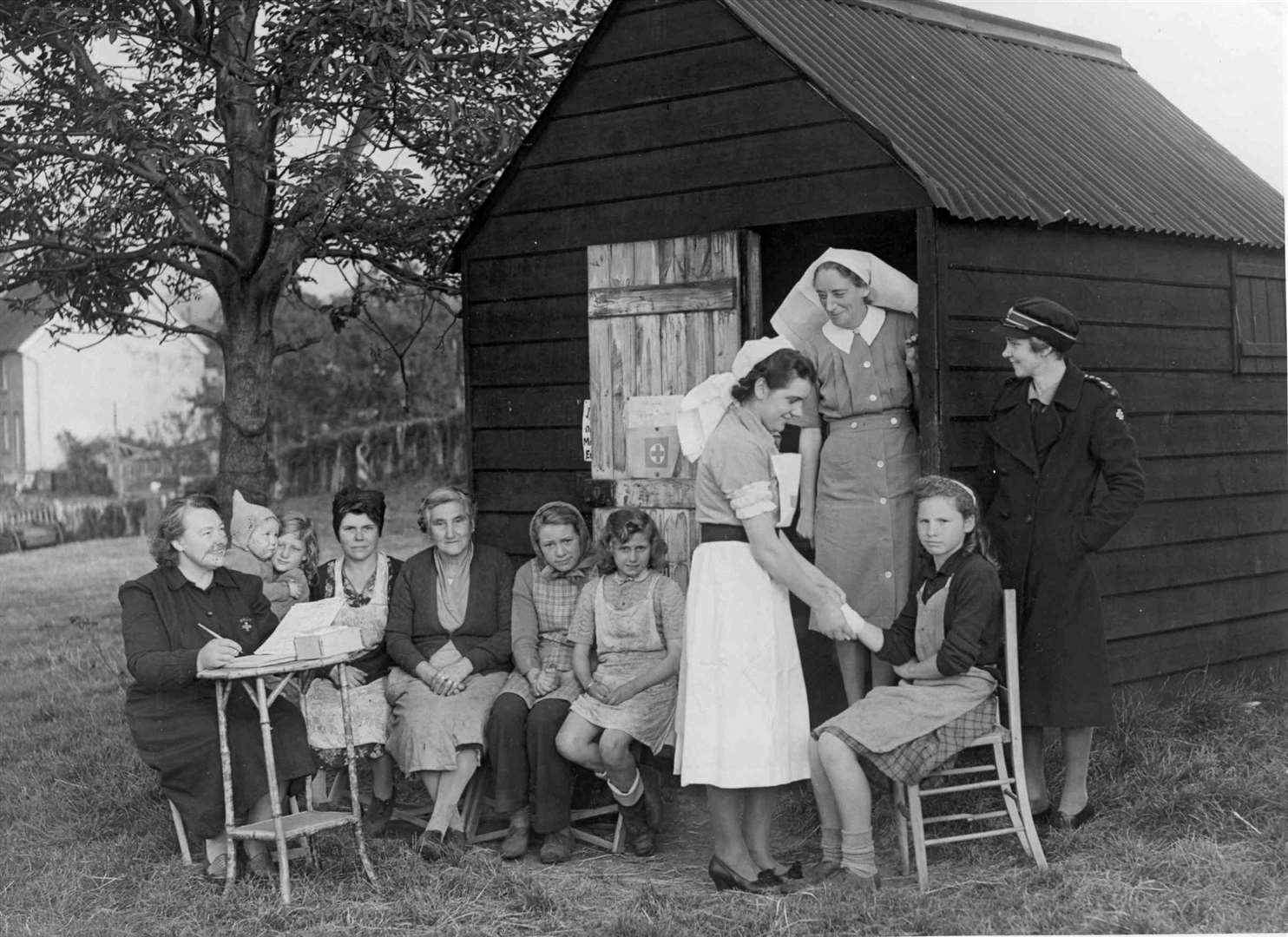 British Red Cross members checking on the health of hoppers at Tutsham Hall, East Farleigh, in the 1950s