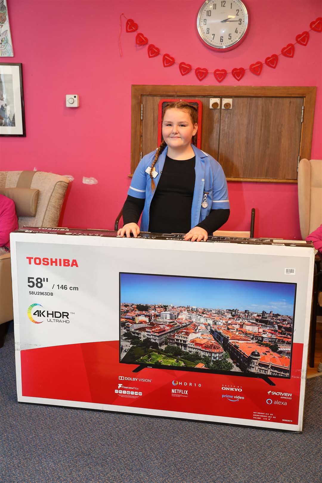 Isabelle with the TV she donated to the home. Picture: Andy Jones