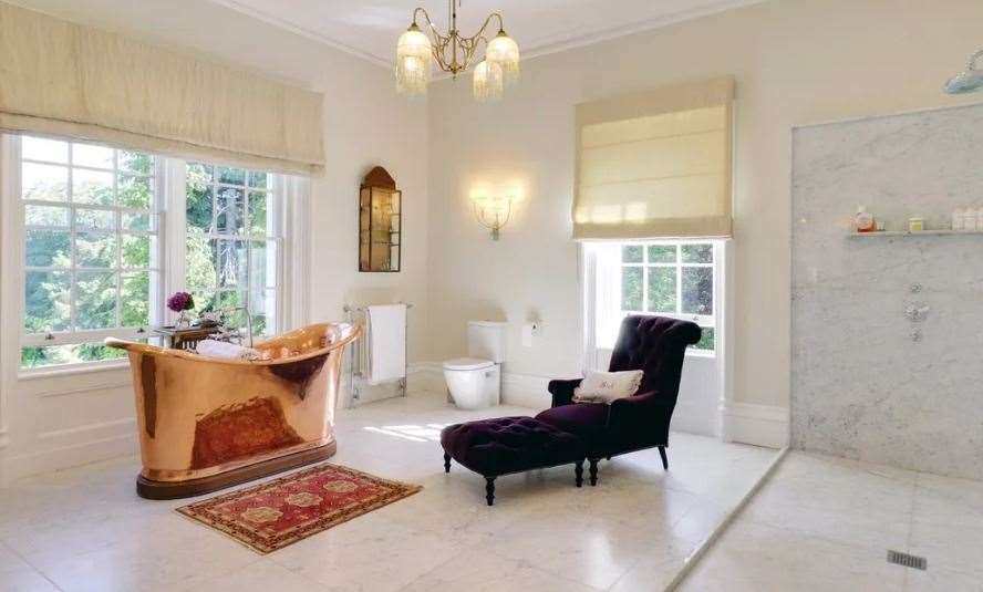 The main en suite bathroom has a luxurious copper roll top bath. Picture: Savills