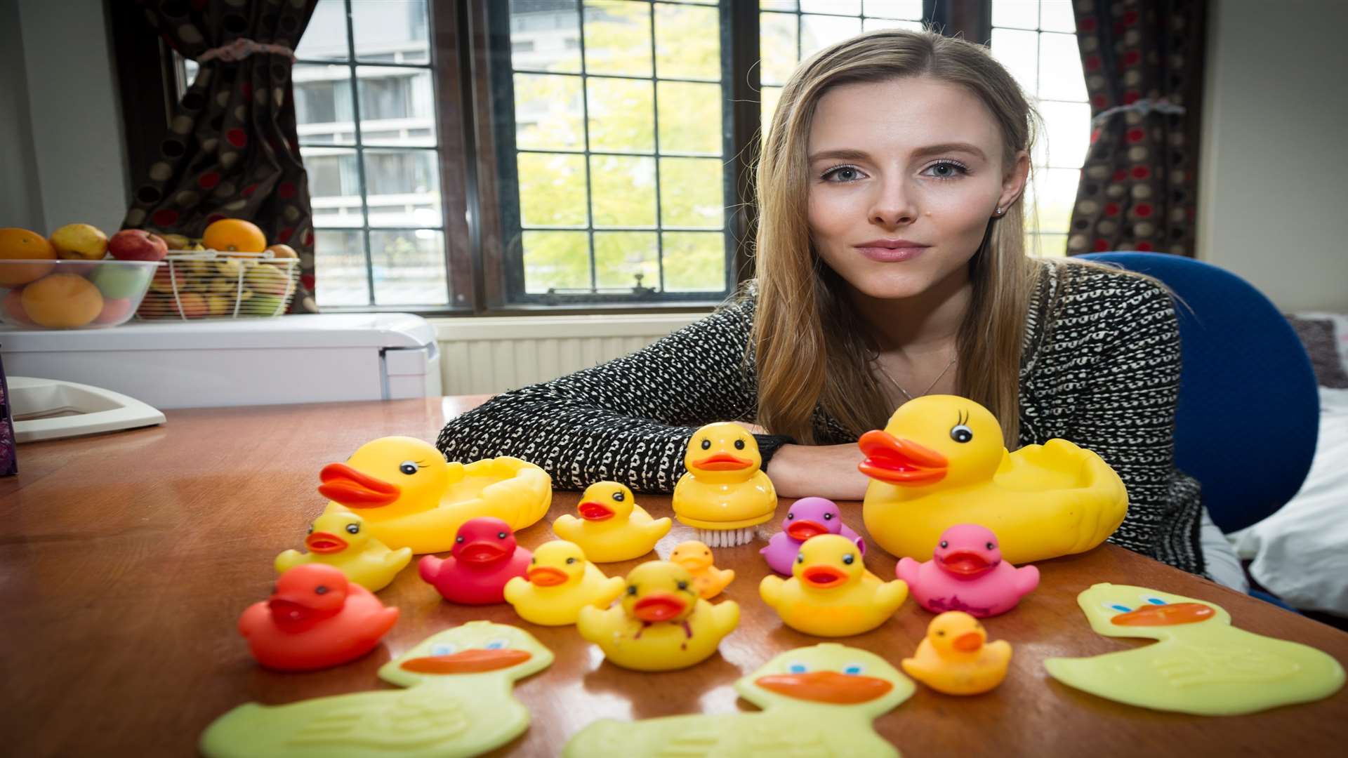 Abbie Coombs with some of the creepy plastic ducks sent by a stalker. Picture: SWNS